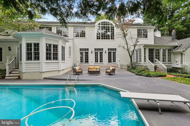 rear view of property featuring a patio area and an outdoor living space