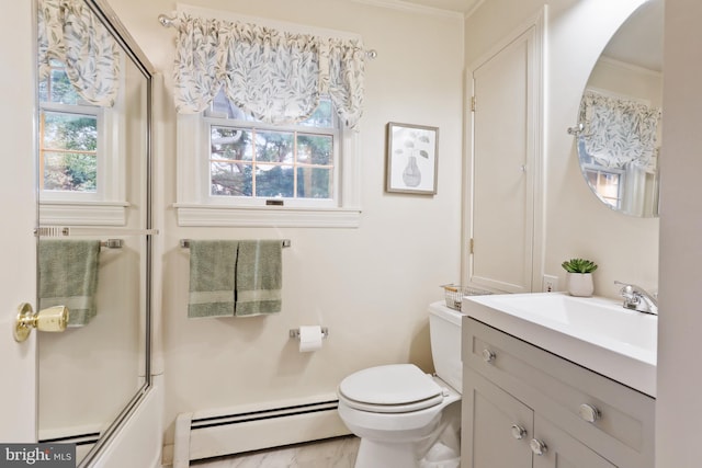 full bathroom featuring crown molding, a baseboard heating unit, vanity, combined bath / shower with glass door, and toilet