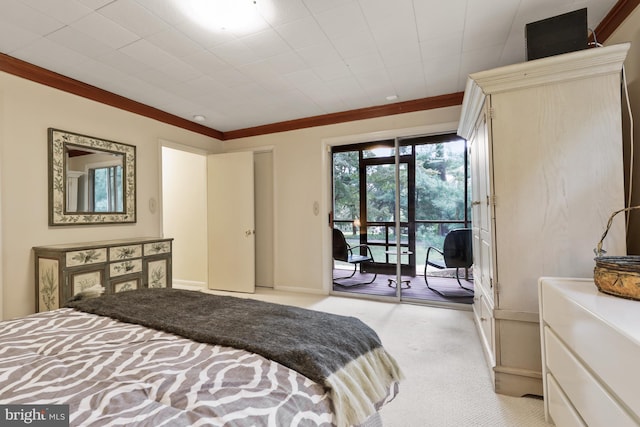 carpeted bedroom with ornamental molding and access to exterior