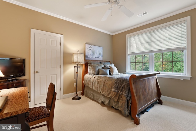 bedroom with ornamental molding, ceiling fan, and carpet