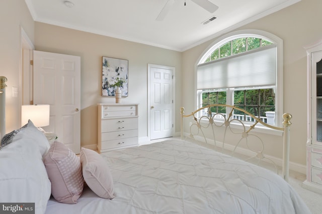 bedroom featuring crown molding, light colored carpet, and ceiling fan