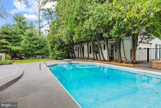 view of swimming pool with a diving board