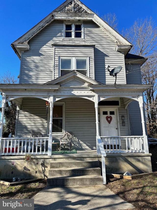 victorian house featuring covered porch