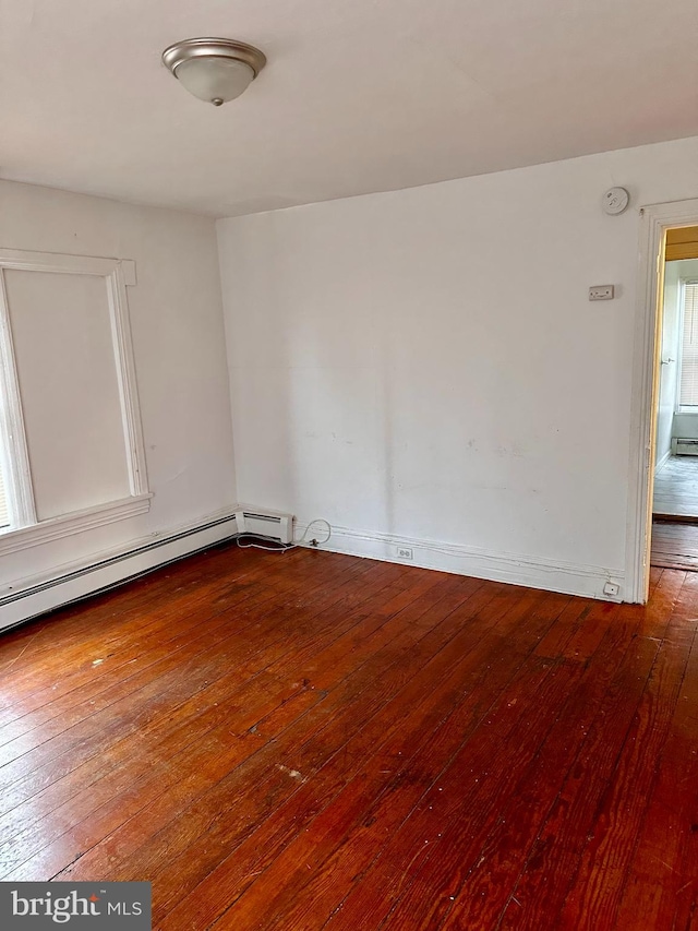 spare room featuring hardwood / wood-style floors and baseboard heating