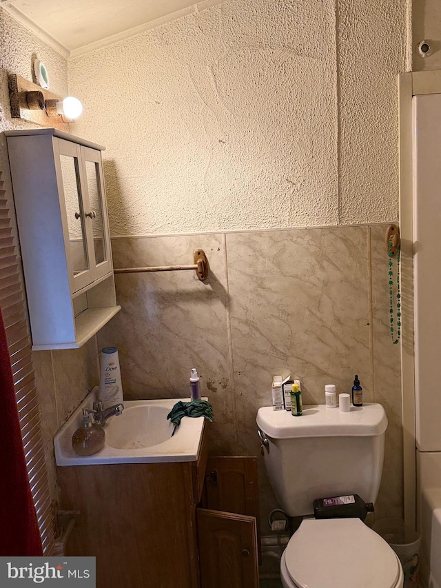 bathroom featuring crown molding, vanity, and toilet