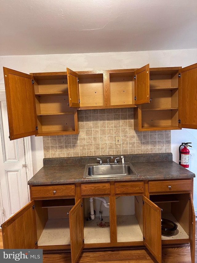 kitchen featuring tasteful backsplash and sink