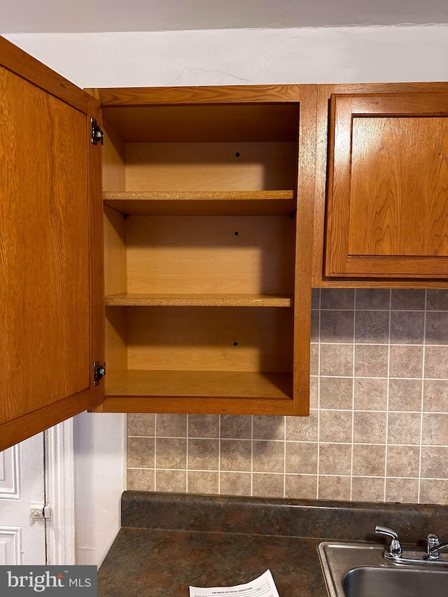 interior details featuring tasteful backsplash and sink