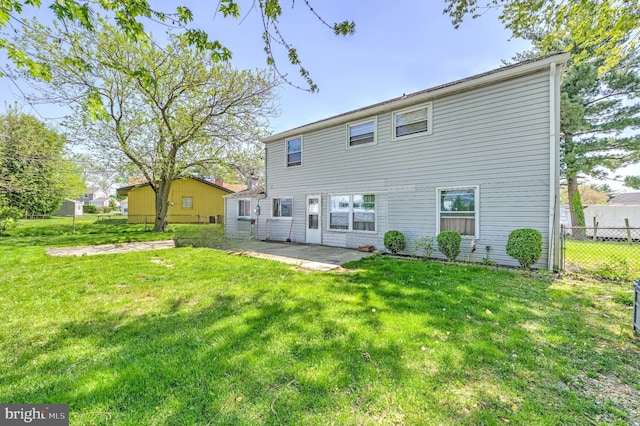 rear view of property with a lawn