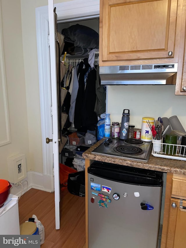 kitchen with electric cooktop, dishwasher, and hardwood / wood-style floors