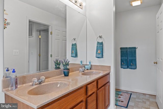 bathroom with dual bowl vanity and tile flooring