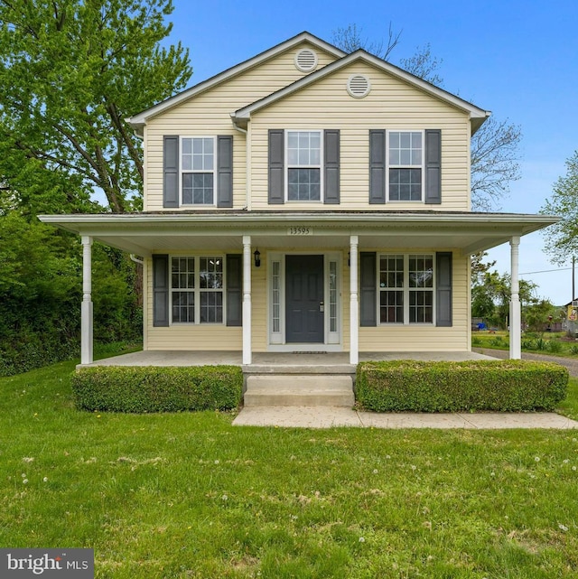 view of front facade with a front yard and a porch