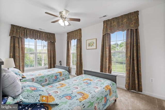 bedroom with carpet flooring, ceiling fan, and multiple windows