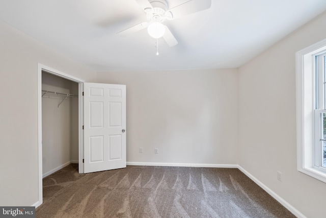 unfurnished bedroom featuring multiple windows, ceiling fan, a closet, and carpet