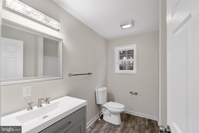 bathroom with vanity, wood-type flooring, and toilet