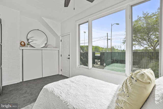 bedroom with dark colored carpet and ceiling fan