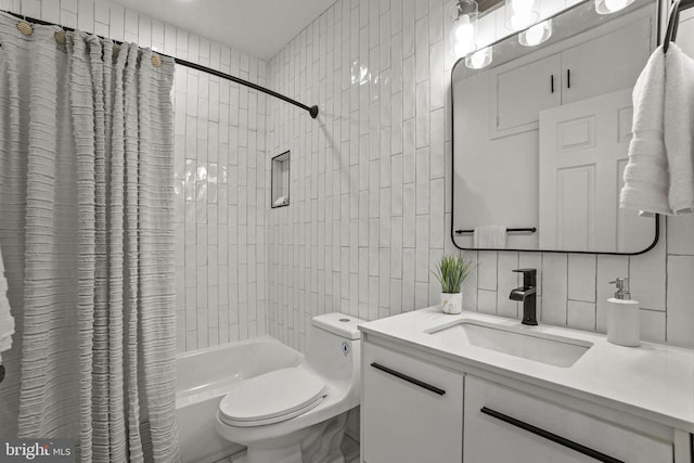 full bathroom with vanity, toilet, shower / bath combo with shower curtain, and tile walls