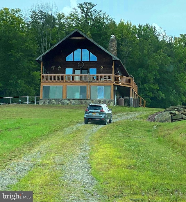 log-style house with a front lawn