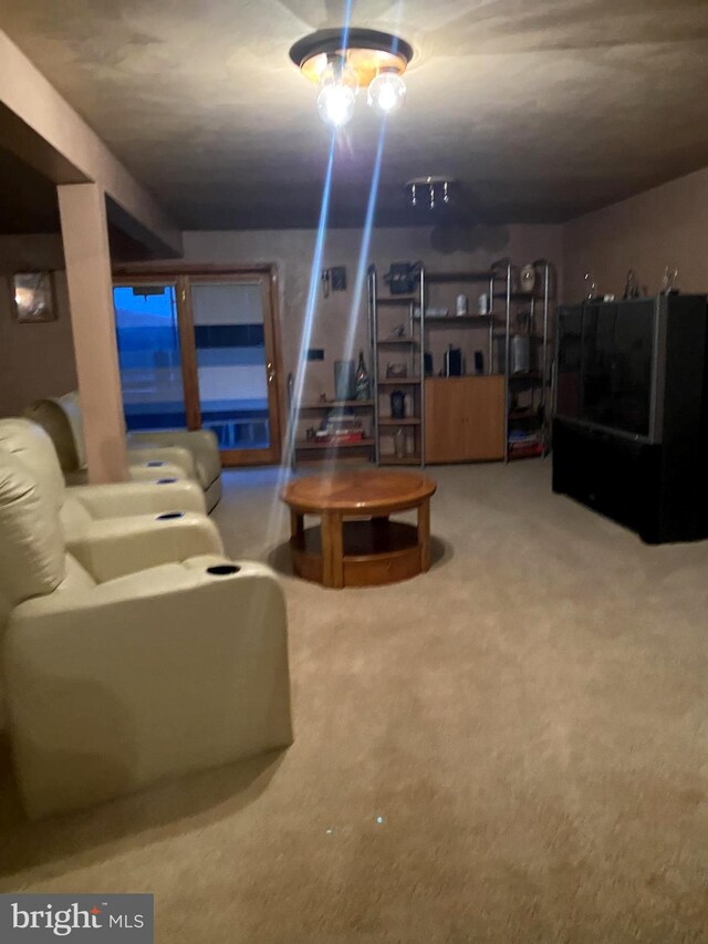 living room with light carpet and a chandelier