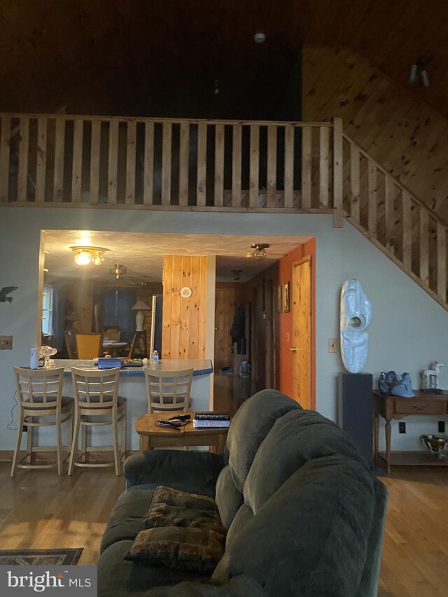 living room with a high ceiling and hardwood / wood-style floors