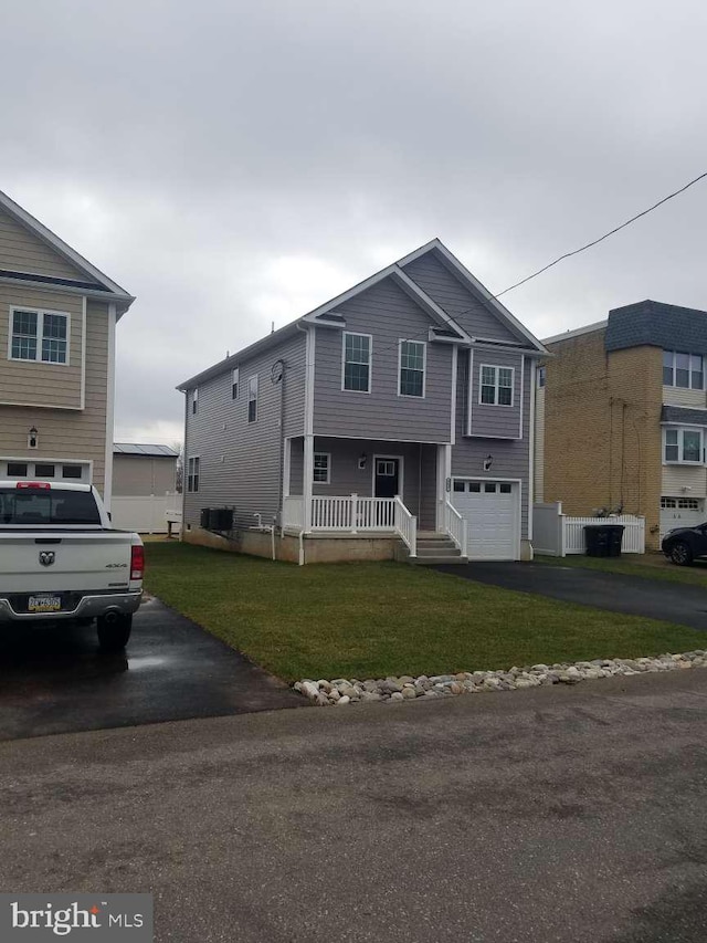 view of front facade with a porch, a garage, and a front lawn