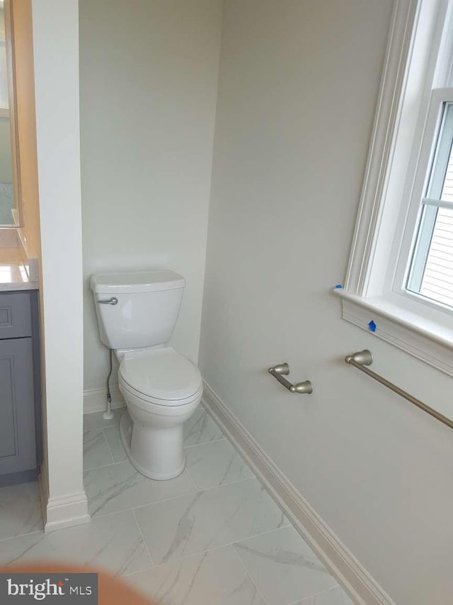 bathroom featuring toilet and vanity