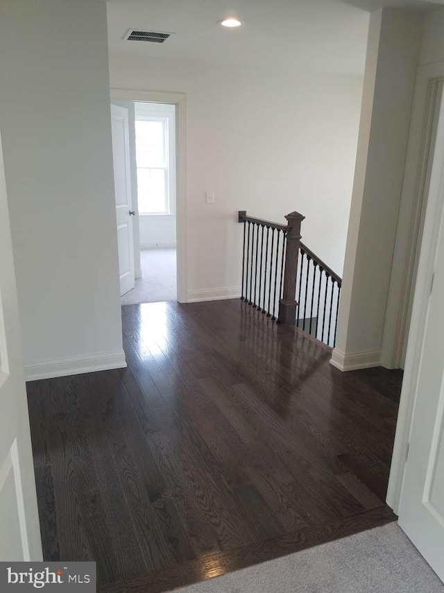 corridor with dark hardwood / wood-style floors