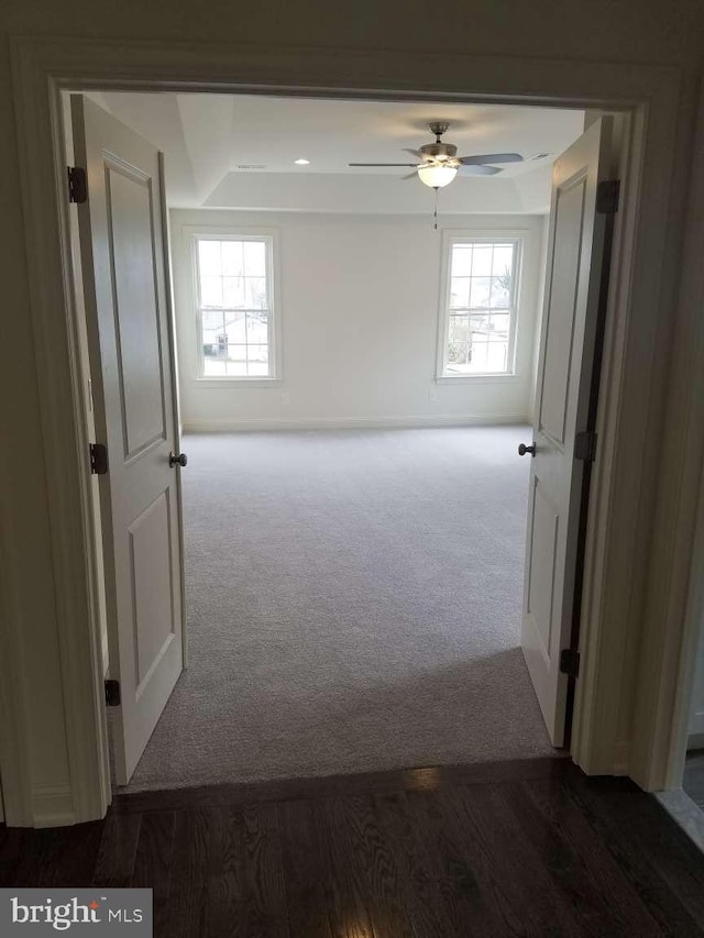 carpeted spare room featuring ceiling fan