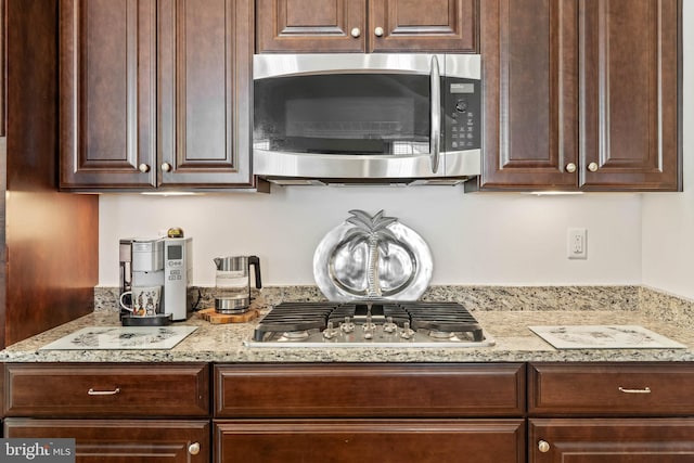 kitchen featuring dark brown cabinetry and stainless steel appliances