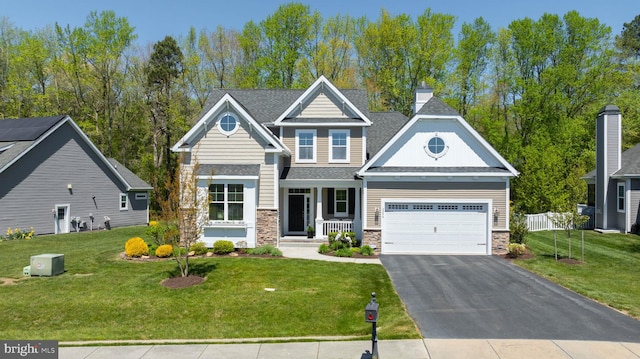 craftsman-style house with a front yard and a garage