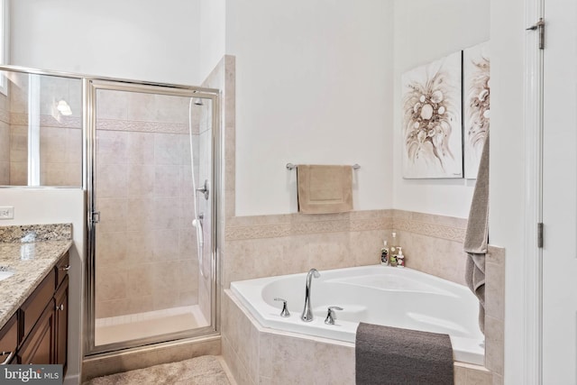 bathroom with vanity and separate shower and tub