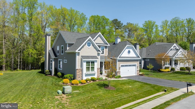 view of front of home featuring a garage and a front lawn