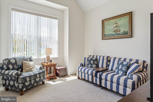 carpeted living room featuring vaulted ceiling