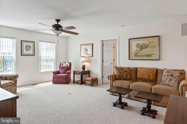 living room featuring light carpet and ceiling fan