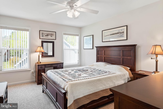 bedroom featuring ceiling fan and light carpet