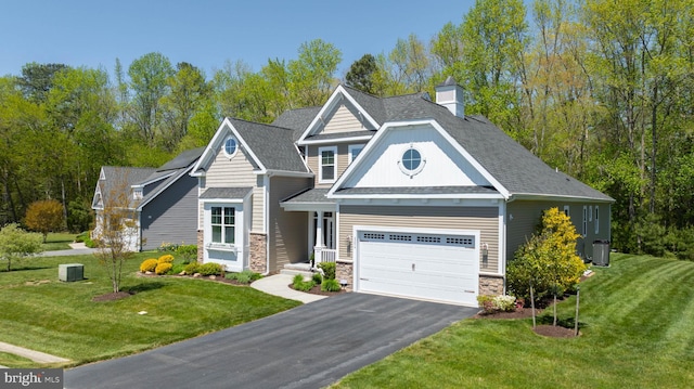 craftsman inspired home with a front yard and a garage