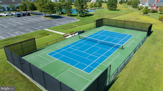 view of sport court featuring a yard