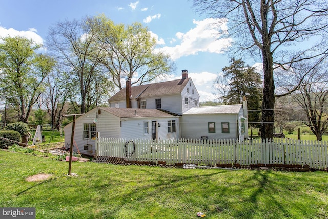 back of house with a lawn