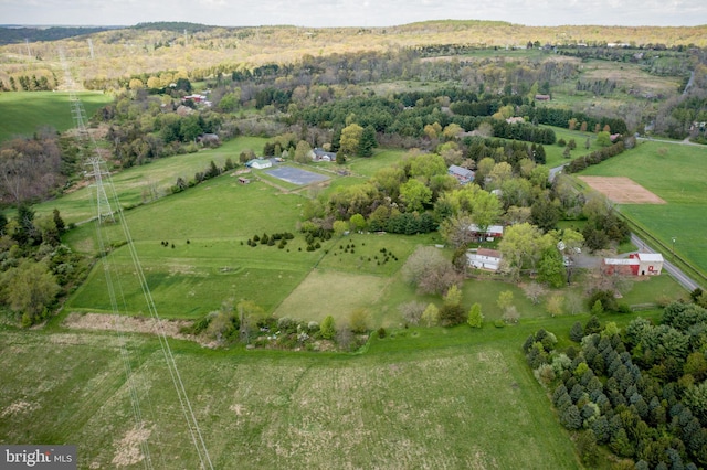 birds eye view of property with a rural view