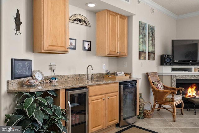 kitchen with wine cooler, crown molding, light tile floors, and light stone countertops