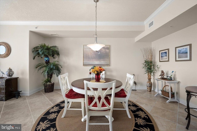 tiled dining area featuring ornamental molding