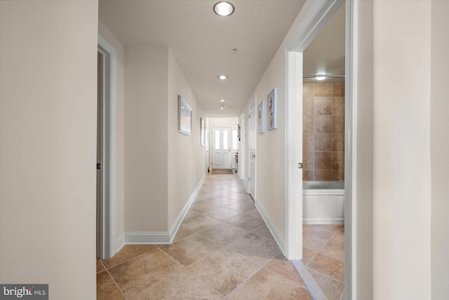 corridor with light tile floors