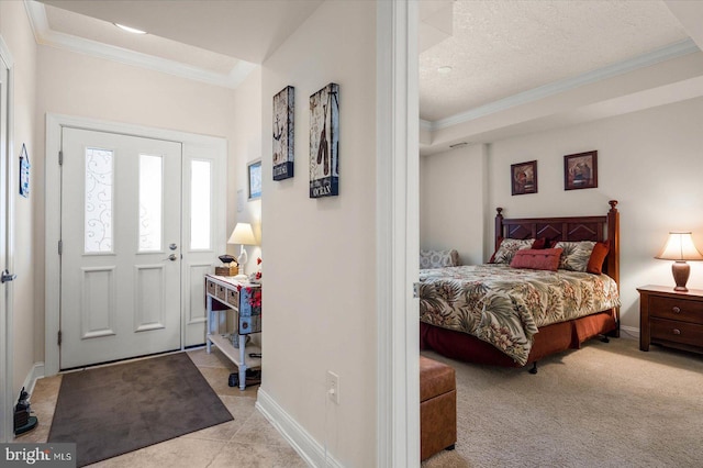 carpeted foyer entrance with crown molding and a textured ceiling