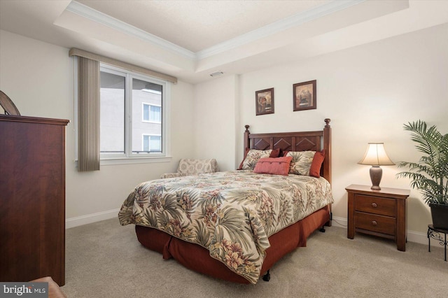 carpeted bedroom featuring a raised ceiling and crown molding