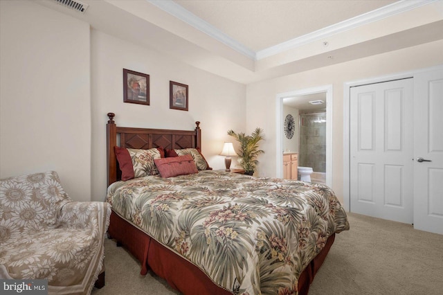 bedroom featuring ensuite bath, carpet, and crown molding