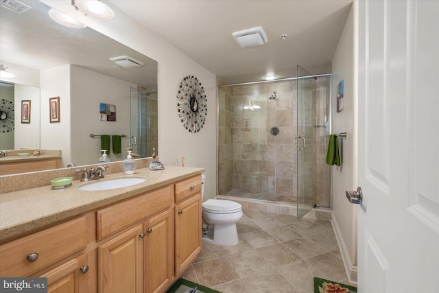 bathroom featuring walk in shower, toilet, large vanity, and tile floors