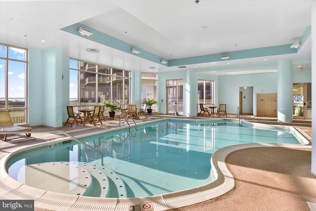 view of pool with a hot tub