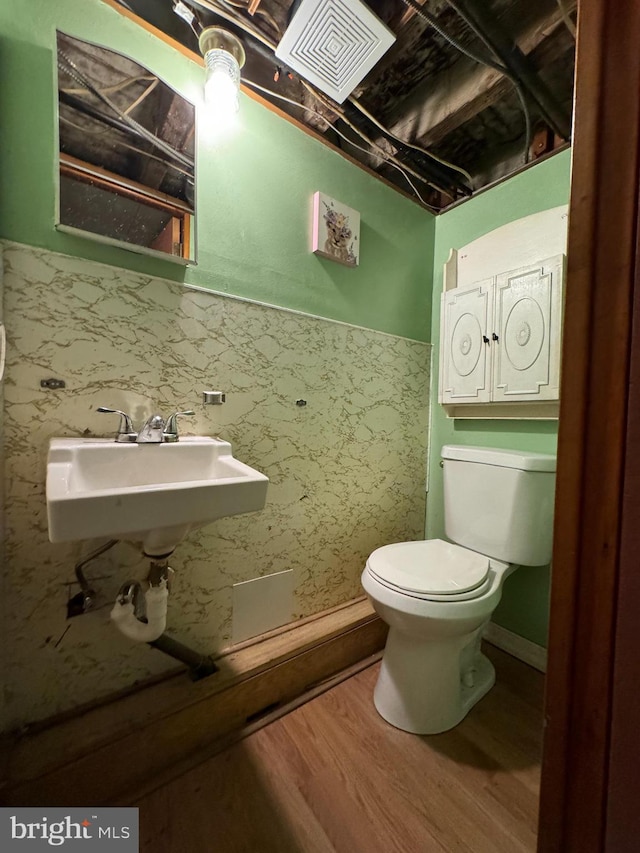 bathroom with wood-type flooring, sink, and toilet