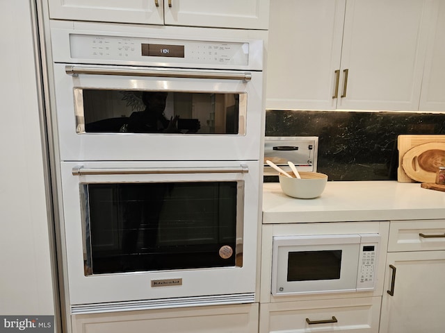 interior space with white appliances and tasteful backsplash