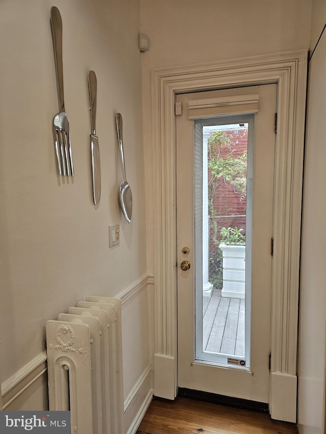 entryway featuring radiator and hardwood / wood-style floors