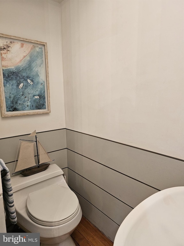 bathroom featuring hardwood / wood-style floors and toilet